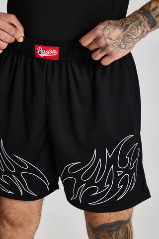 Erkek model üzerinde siyah Inferno Mesh Short, beldeki kırmızı Passion etiketi ve alev deseni yakın çekim